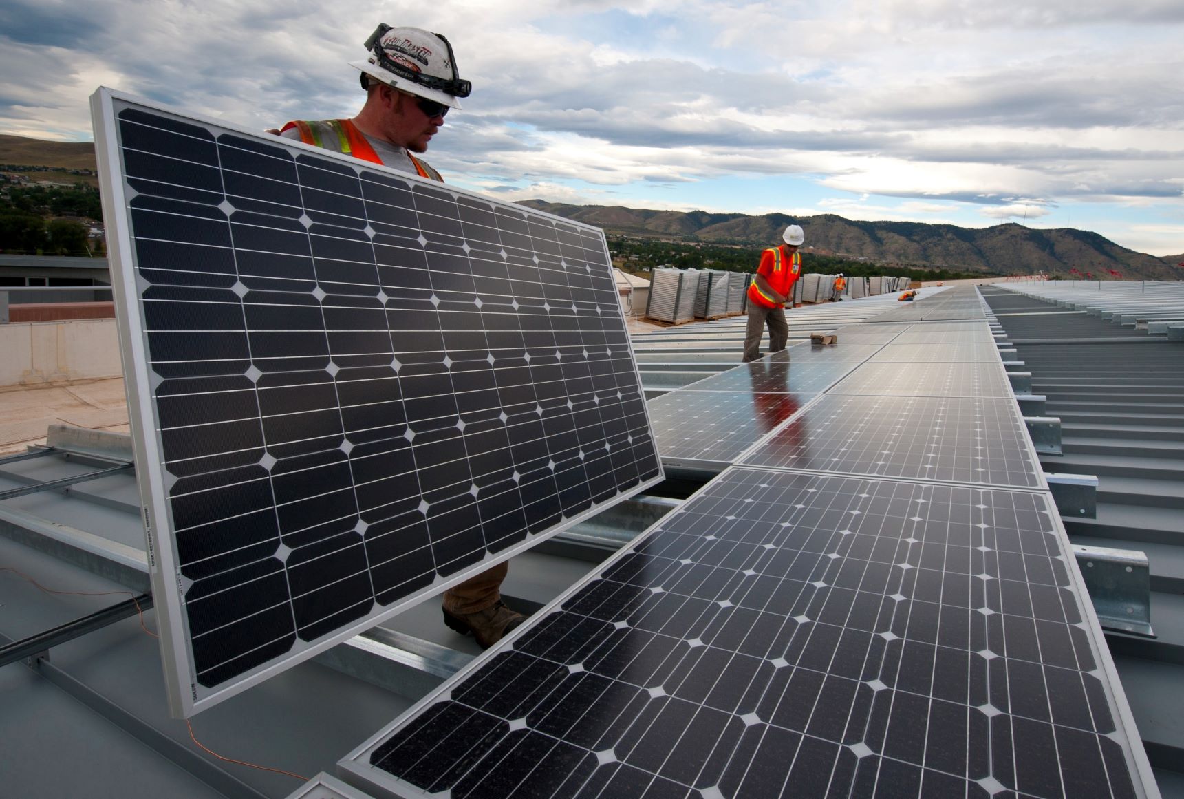 workers installing solar panels
